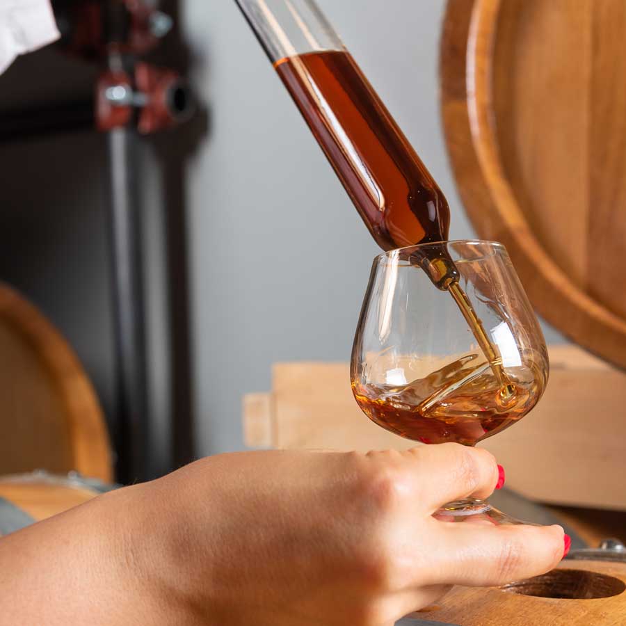 Sampling of whiskey from a barrel 