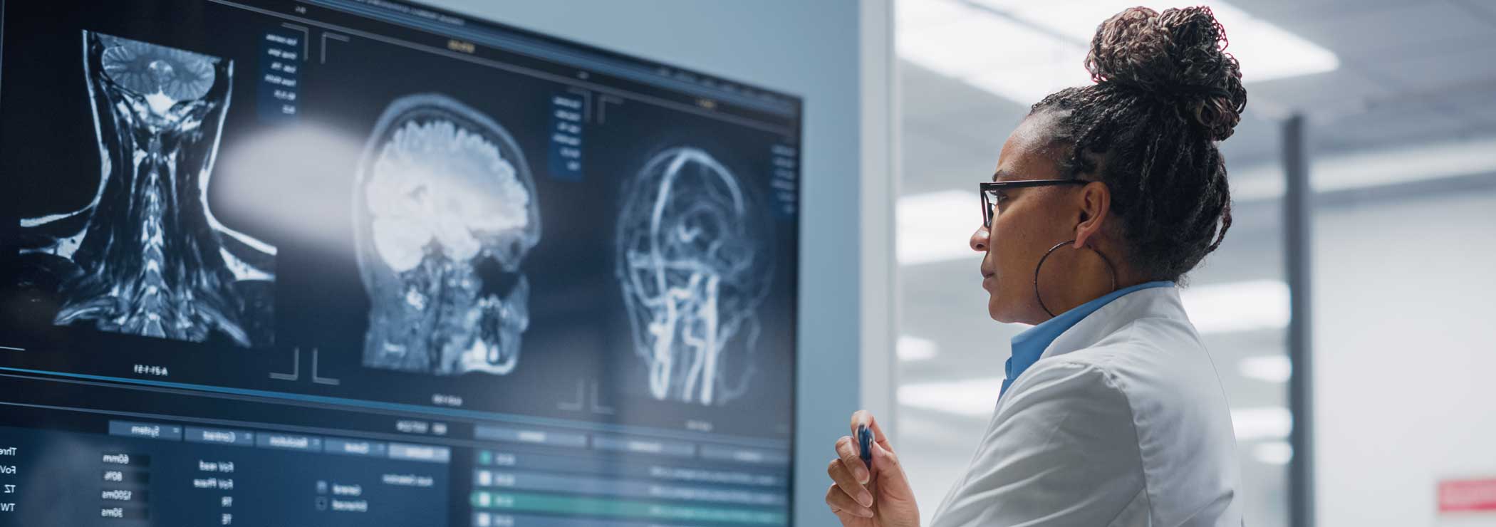 Symbol of development in medical devices: a woman looks at MRI images